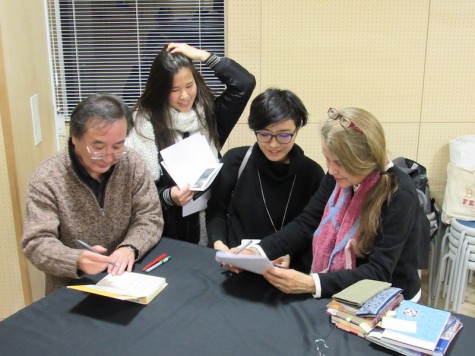 The Japanese translator for "Habibi" (Left) and Ms. Nye (Right) sign books for students