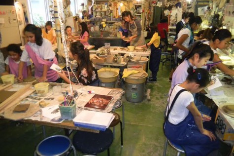 The Human Rights and Refugees Class working with fifth graders with pottery making.