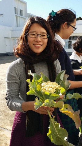 Julia (12) holding a freshly harvested Cauliflower