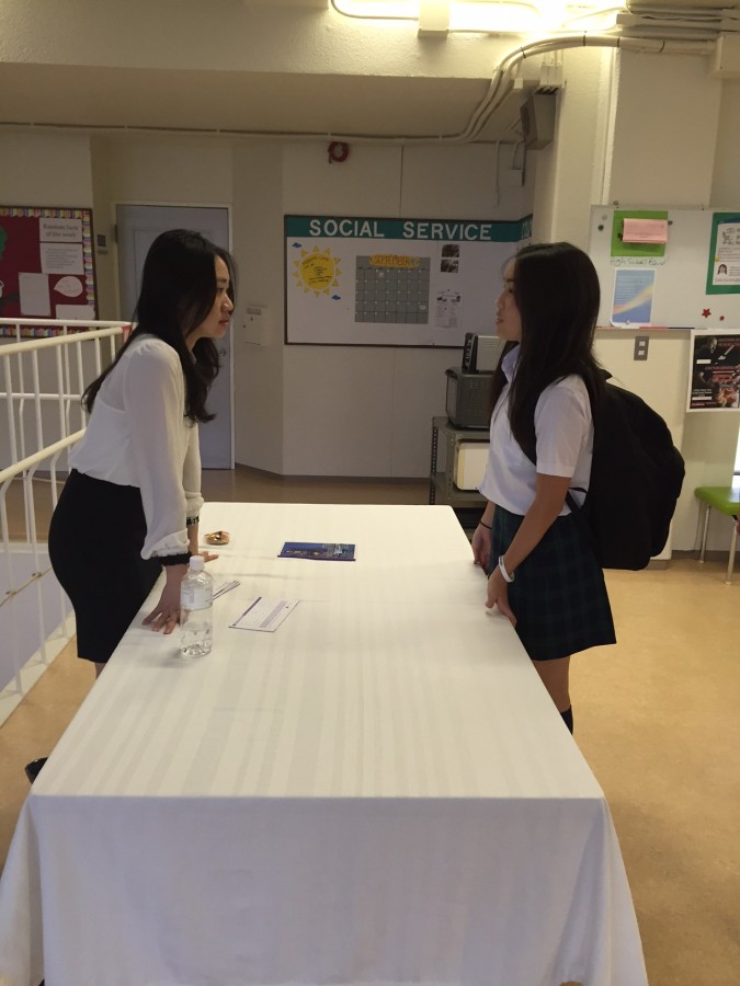 Mirei (11) talks to a college rep from Hong Kong University of Science and Technology. 