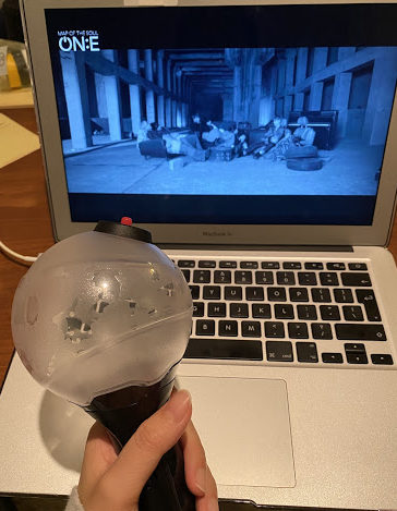 Hana K. enjoying a virtual concert for BTS MAP OF THE SOUL ON:E while holding her BTS light stick. 
Photo Credit: Hana K.