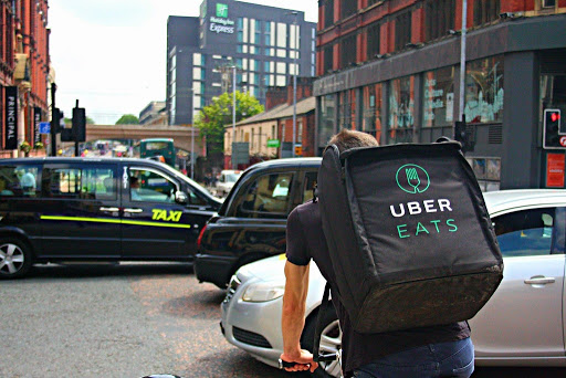UBER Eats Delivery Cyclist Riding Through a Busy Oxford Road in Manchester 