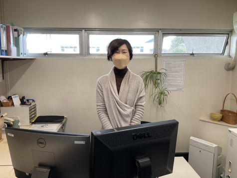 Ms. Tajiri standing behind her desk in her office.