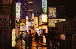 Even in the rain, the glowing signs of Korean eateries light up Shin-Ōkubo’s streets, drawing in customers. 
