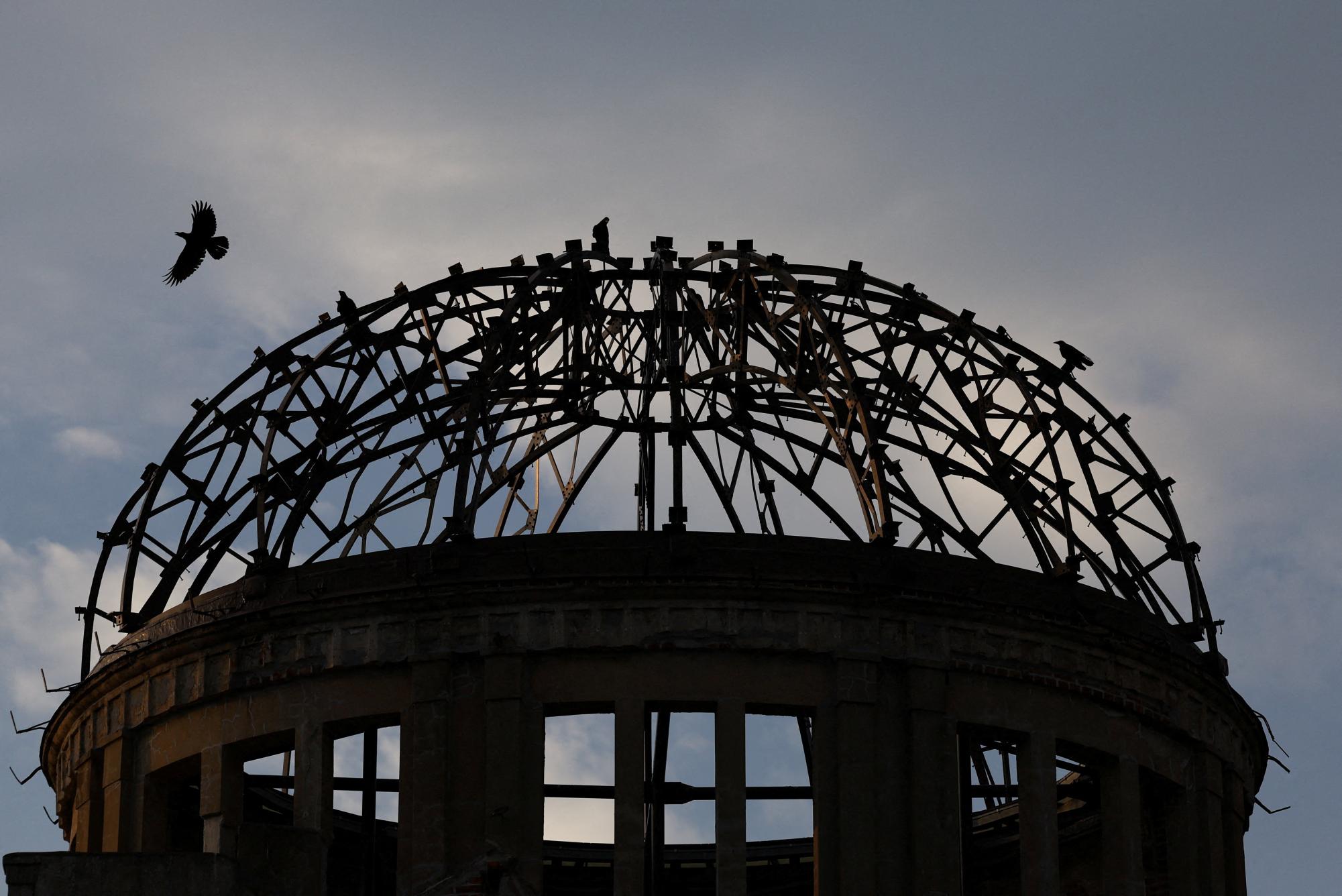 Crows fly over the ruined dome which was abandoned after the World War Two atomic bombing in Hiroshima, western Japan, August 6th, 2025. REUTERS/Kim Kyung-Hoon