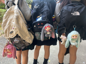 ISSH middle schoolers with matching “NOMMI” blind box figures on their bags. 

